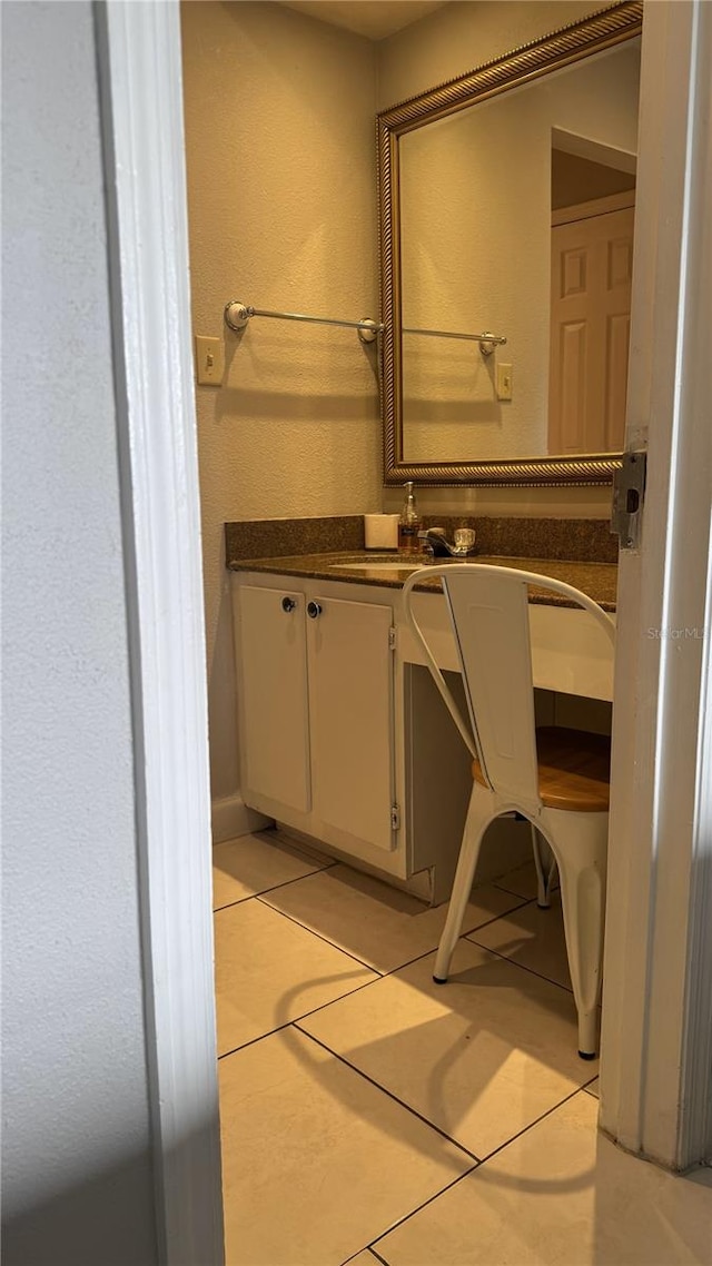 bathroom with tile patterned flooring and vanity