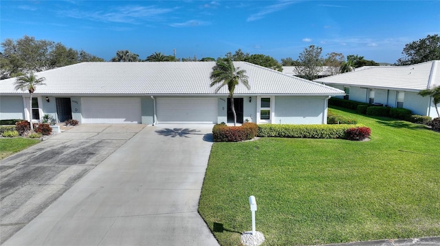 ranch-style house with concrete driveway, a tile roof, an attached garage, a front yard, and stucco siding