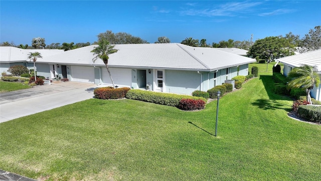 single story home featuring a garage, driveway, a front yard, and a tile roof