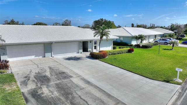 ranch-style home with an attached garage, stucco siding, concrete driveway, and a front yard