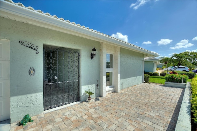 property entrance with stucco siding