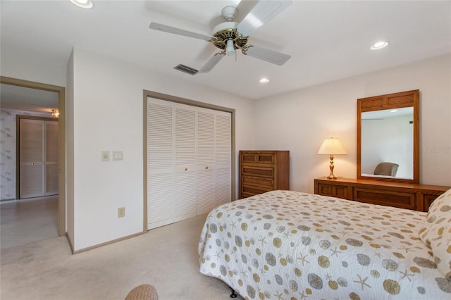 bedroom with recessed lighting, a closet, visible vents, light carpet, and baseboards