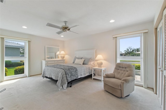 bedroom with light carpet and recessed lighting