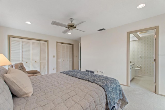 bedroom with multiple closets, recessed lighting, and visible vents