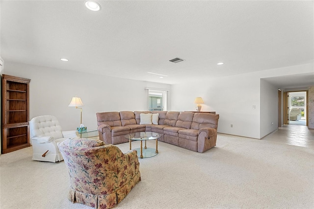 carpeted living room with visible vents and recessed lighting