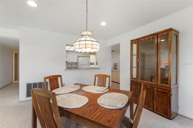 dining room with light carpet, baseboards, visible vents, and recessed lighting