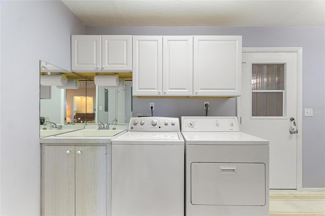 laundry room with independent washer and dryer, a sink, and cabinet space