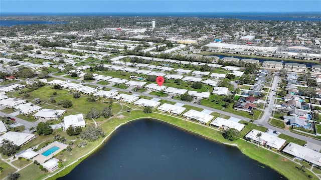 birds eye view of property with a water view and a residential view