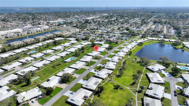 bird's eye view with a water view and a residential view