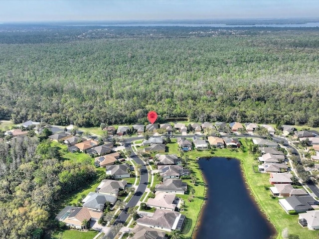 aerial view with a residential view, a view of trees, and a water view