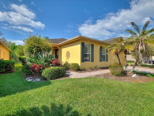 view of home's exterior with a lawn and stucco siding