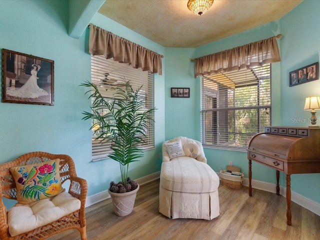 living area with wood finished floors and baseboards