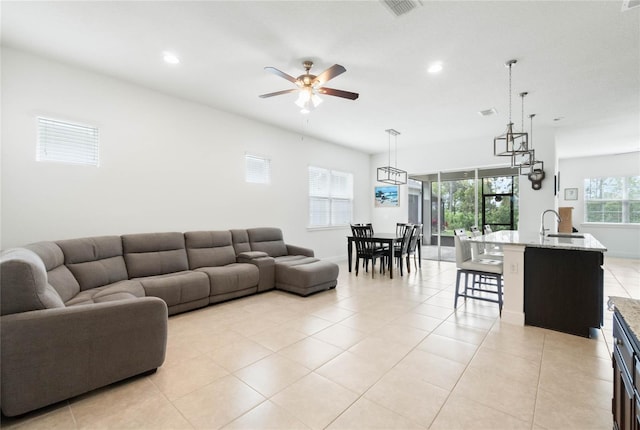 living room featuring visible vents, recessed lighting, light tile patterned floors, baseboards, and ceiling fan