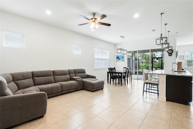 living room with visible vents, light tile patterned floors, a ceiling fan, and recessed lighting