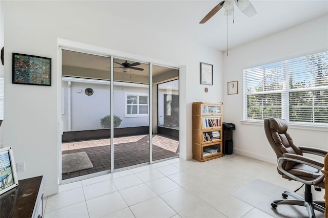 office space featuring light tile patterned flooring, baseboards, and ceiling fan