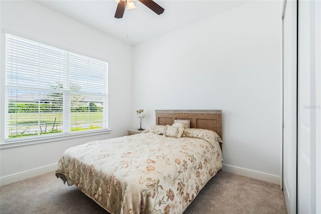 bedroom featuring baseboards, ceiling fan, and carpet flooring