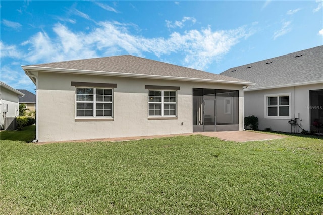 rear view of house with stucco siding, a lawn, cooling unit, and a sunroom