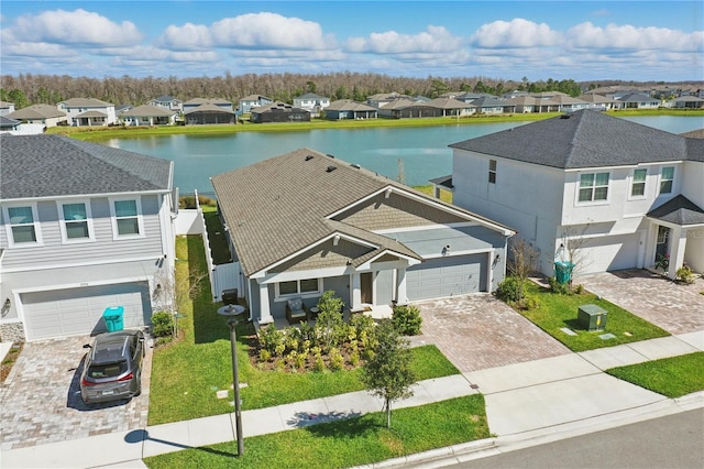 bird's eye view featuring a water view and a residential view