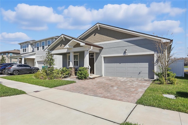 7793 Clove Hitch Way, Orlando, FL 32832 - view of front of property featuring decorative driveway, an attached garage, and stucco siding