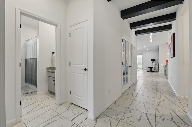 7793 Clove Hitch Way, Orlando, FL 32832 - hall with marble finish floor, baseboards, and beamed ceiling