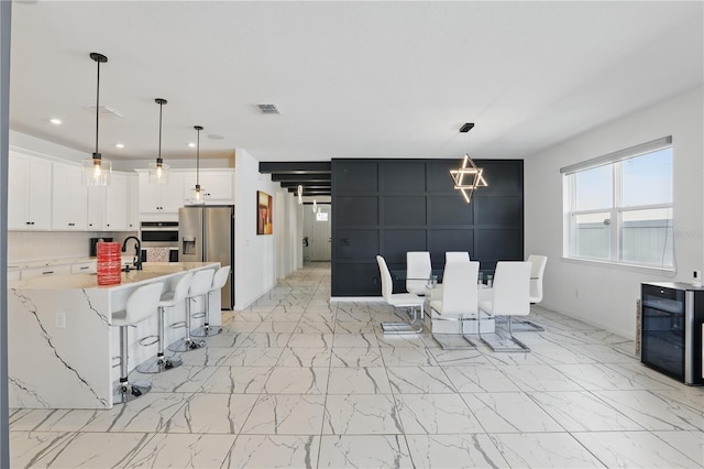 7793 Clove Hitch Way, Orlando, FL 32832 - dining room featuring recessed lighting, marble finish floor, visible vents, and ceiling fan with notable chandelier