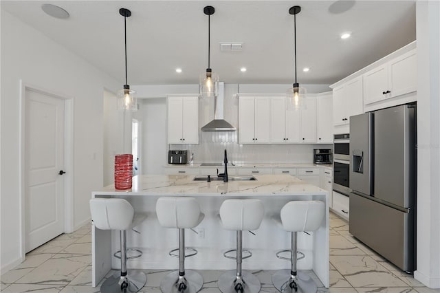7793 Clove Hitch Way, Orlando, FL 32832 - kitchen with marble finish floor, appliances with stainless steel finishes, backsplash, and wall chimney range hood