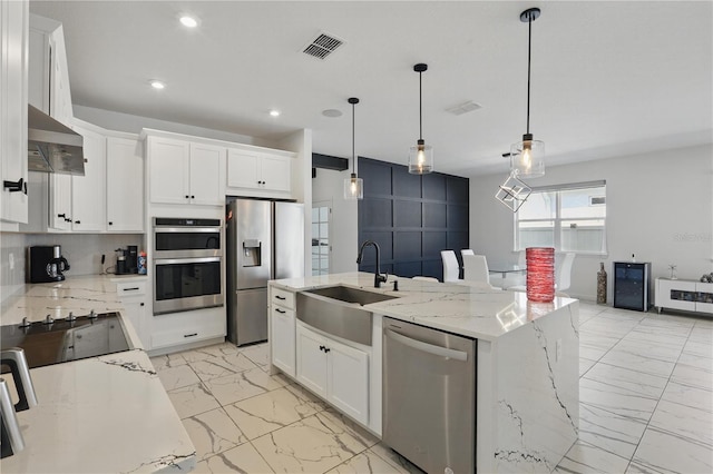 7793 Clove Hitch Way, Orlando, FL 32832 - kitchen with marble finish floor, wall chimney range hood, stainless steel appliances, and a sink