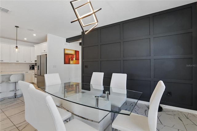 7793 Clove Hitch Way, Orlando, FL 32832 - dining area with marble finish floor, visible vents, a decorative wall, and recessed lighting