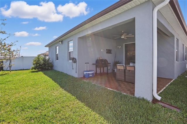 7793 Clove Hitch Way, Orlando, FL 32832 - view of side of home featuring ceiling fan, fence, a lawn, stucco siding, and a patio area
