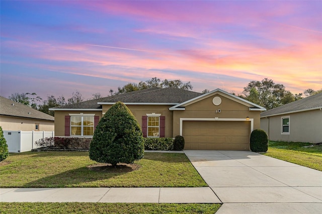 ranch-style house with a garage, a front yard, fence, and stucco siding