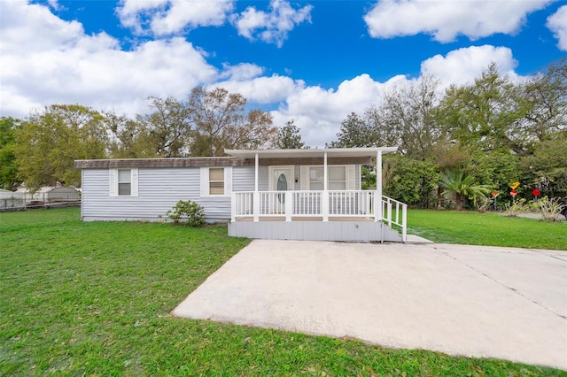 manufactured / mobile home with covered porch and a front lawn