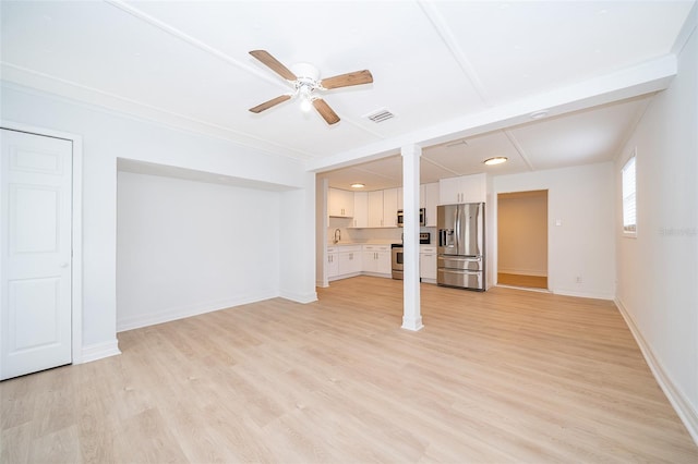 unfurnished living room with light wood-style floors, visible vents, ceiling fan, and baseboards