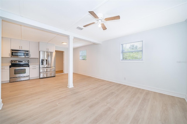 interior space with light wood-type flooring, decorative columns, visible vents, and baseboards