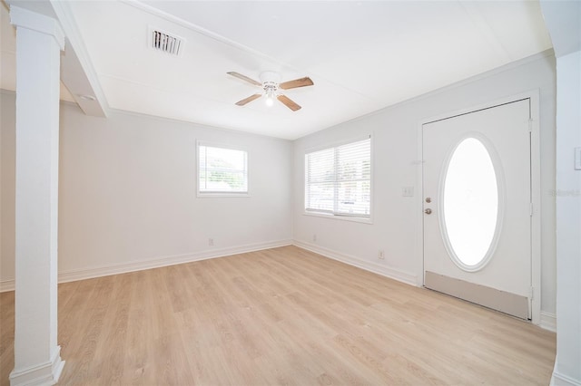 foyer entrance featuring baseboards, visible vents, ceiling fan, and light wood finished floors