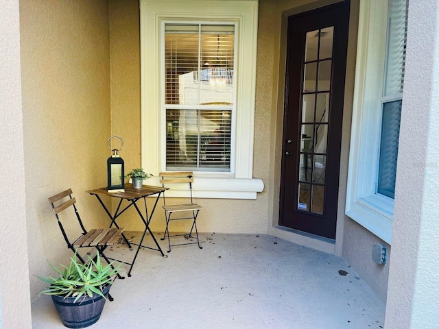 view of exterior entry with stucco siding