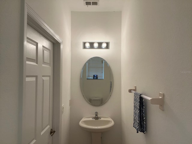 bathroom featuring visible vents and a sink