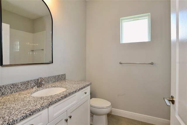 full bath with tile patterned flooring, toilet, vanity, baseboards, and a shower