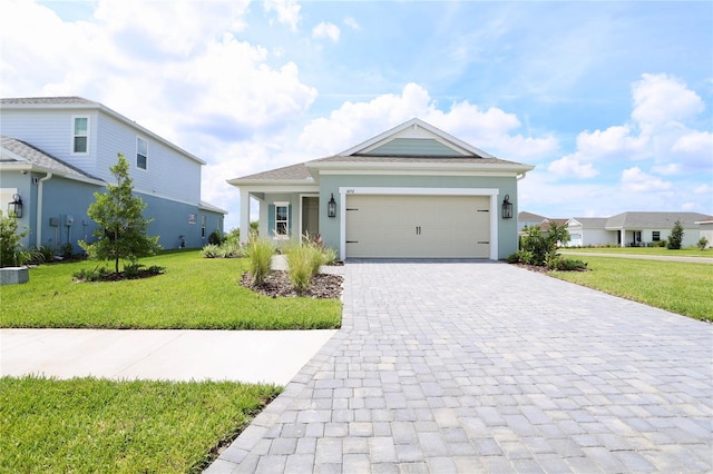14552 Skipping Stone Loop, Parrish, FL 34219 - ranch-style home featuring a garage, decorative driveway, a front lawn, and stucco siding