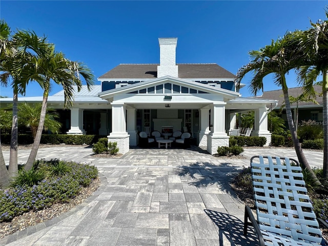 14552 Skipping Stone Loop, Parrish, FL 34219 - exterior space with covered porch and a chimney