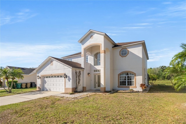 view of front facade with a front yard, stucco siding, french doors, a garage, and driveway