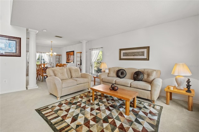 living area with visible vents, light colored carpet, a textured ceiling, and decorative columns