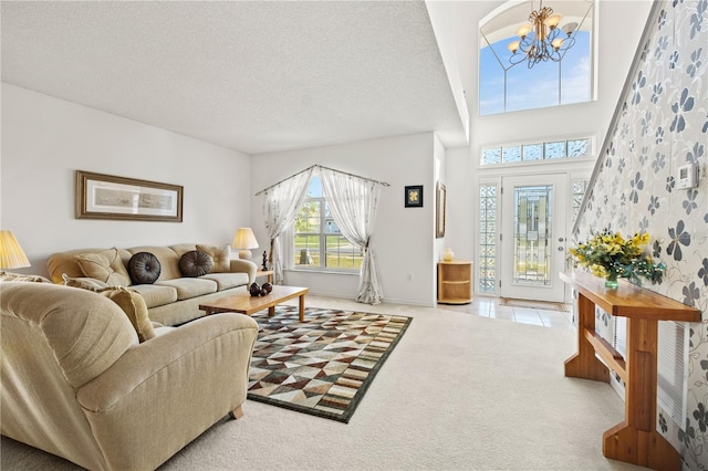 living room featuring carpet, a high ceiling, an inviting chandelier, tile patterned floors, and a textured ceiling