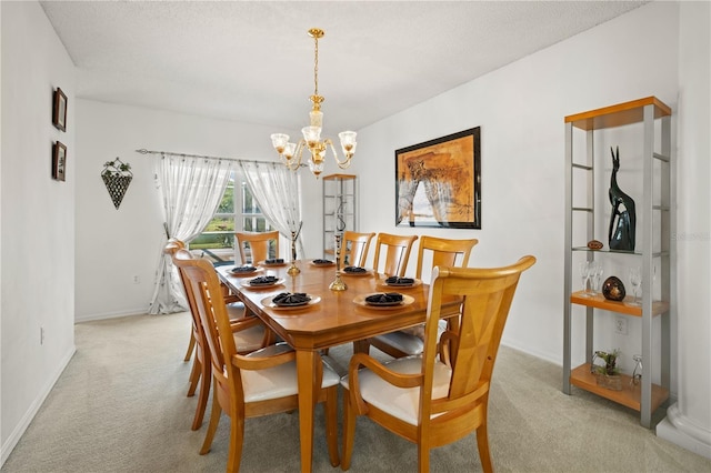 dining space with baseboards, light colored carpet, a chandelier, and a textured ceiling