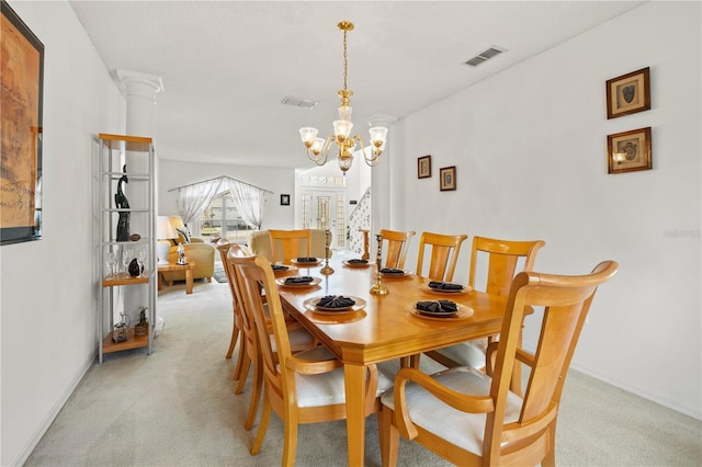 dining room with visible vents, light colored carpet, and an inviting chandelier