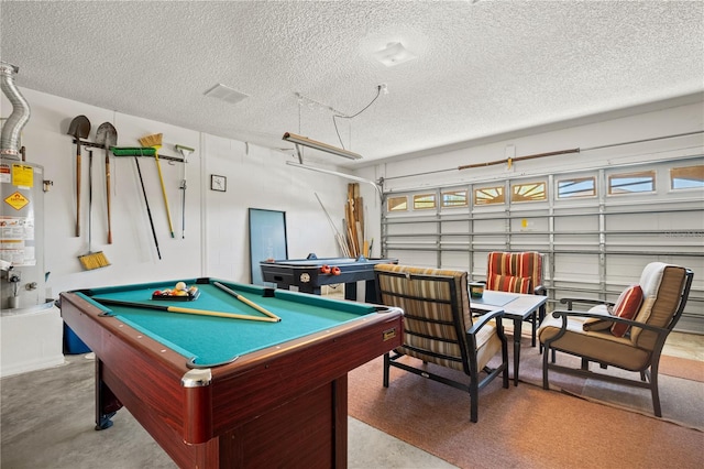 playroom featuring finished concrete floors, gas water heater, a garage, a textured ceiling, and billiards