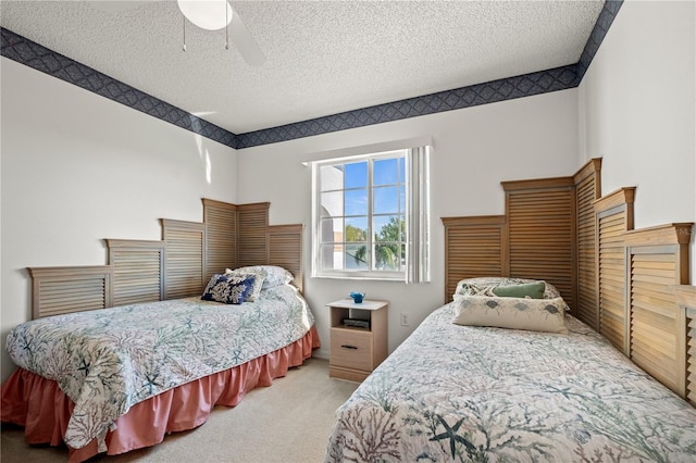 bedroom featuring carpet floors, a textured ceiling, and ceiling fan