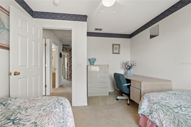 bedroom with visible vents, light carpet, a textured ceiling, baseboards, and attic access