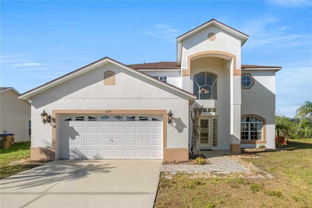 view of front of property featuring concrete driveway, an attached garage, and stucco siding