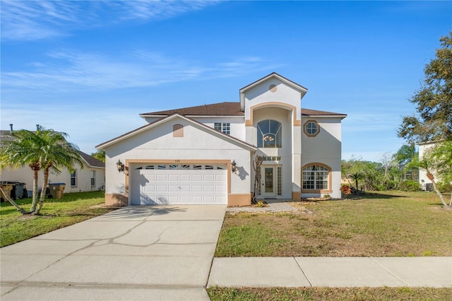 mediterranean / spanish-style house featuring a front yard, concrete driveway, a garage, and stucco siding