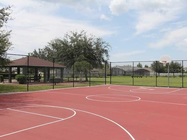 view of basketball court with community basketball court and fence